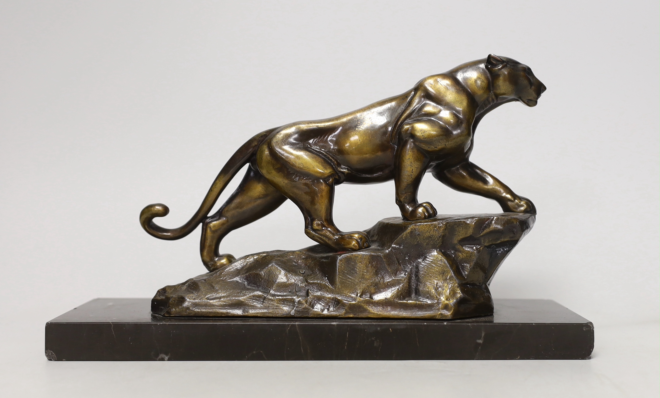 A French Art Deco spelter model of a panther, on marble base, 28cm long